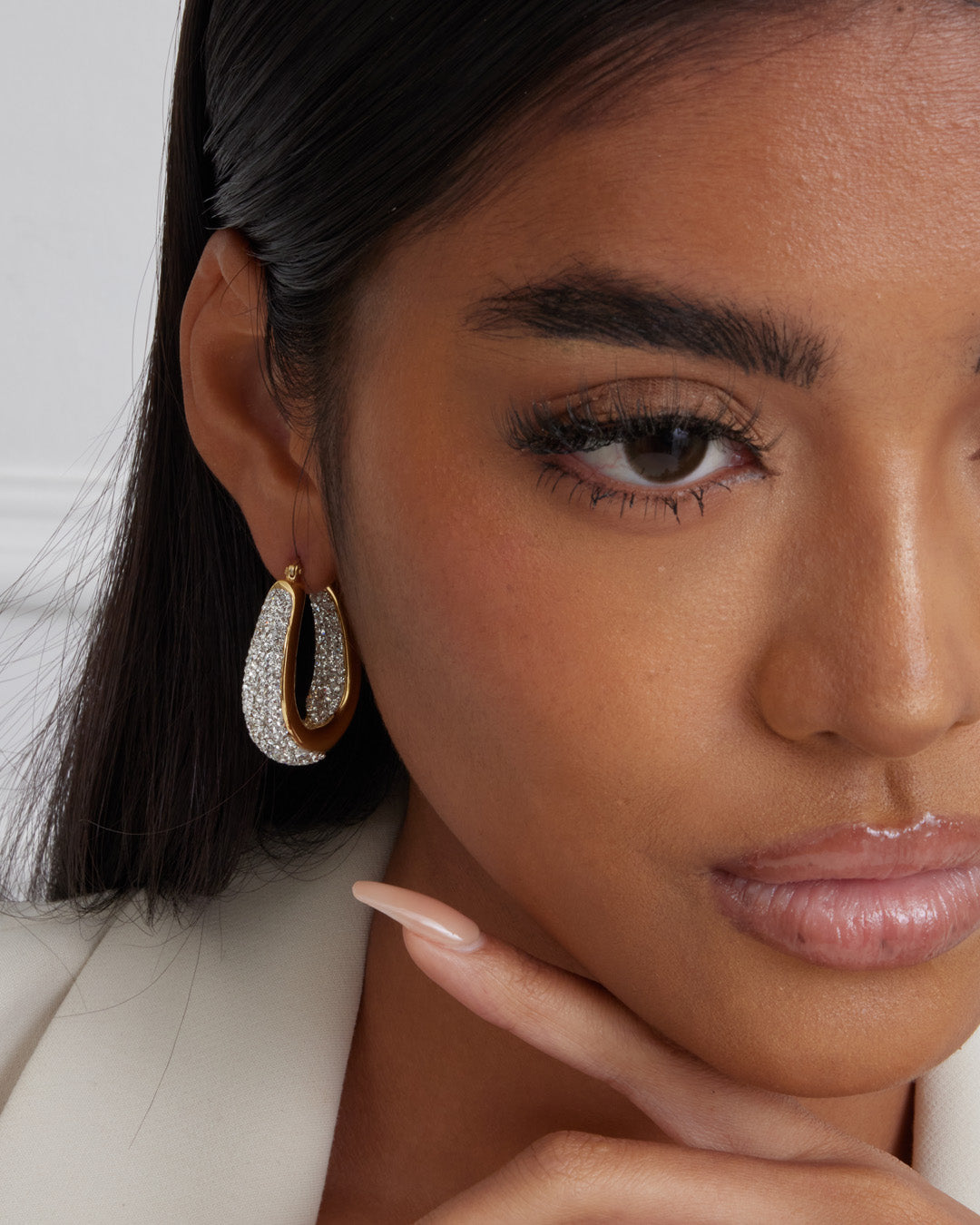 This is the product picture of chunky elegant hoop earrings with crystals plated in gold in sterling silver material