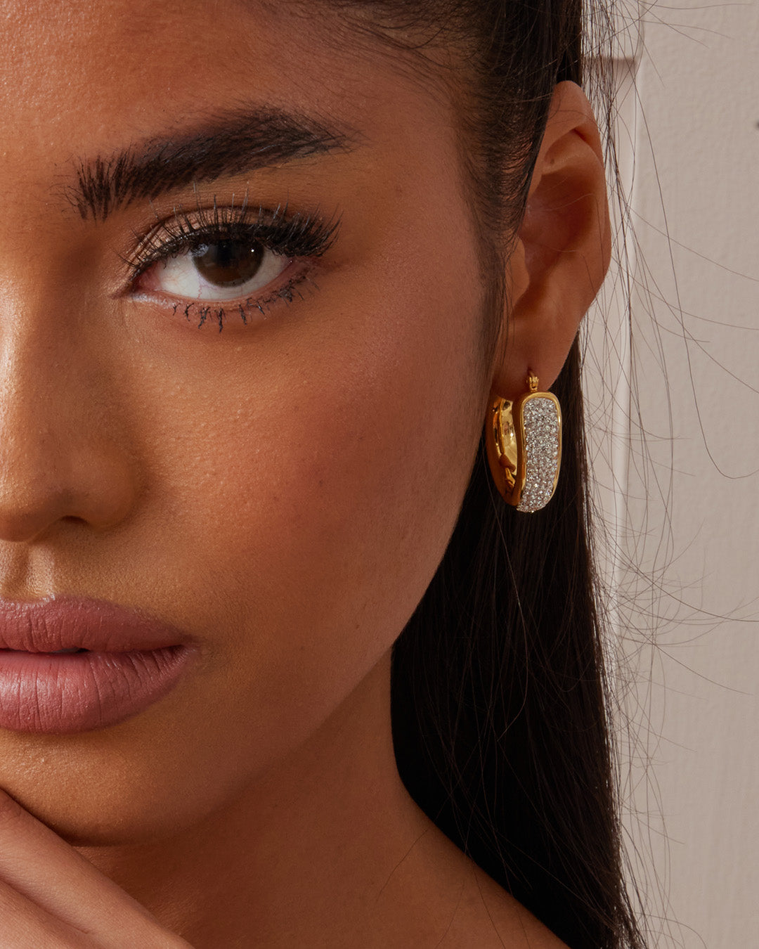 This is the product picture of a chunky statement elegant hoop earrings with micro pavé crystals plated in gold in sterling silver material