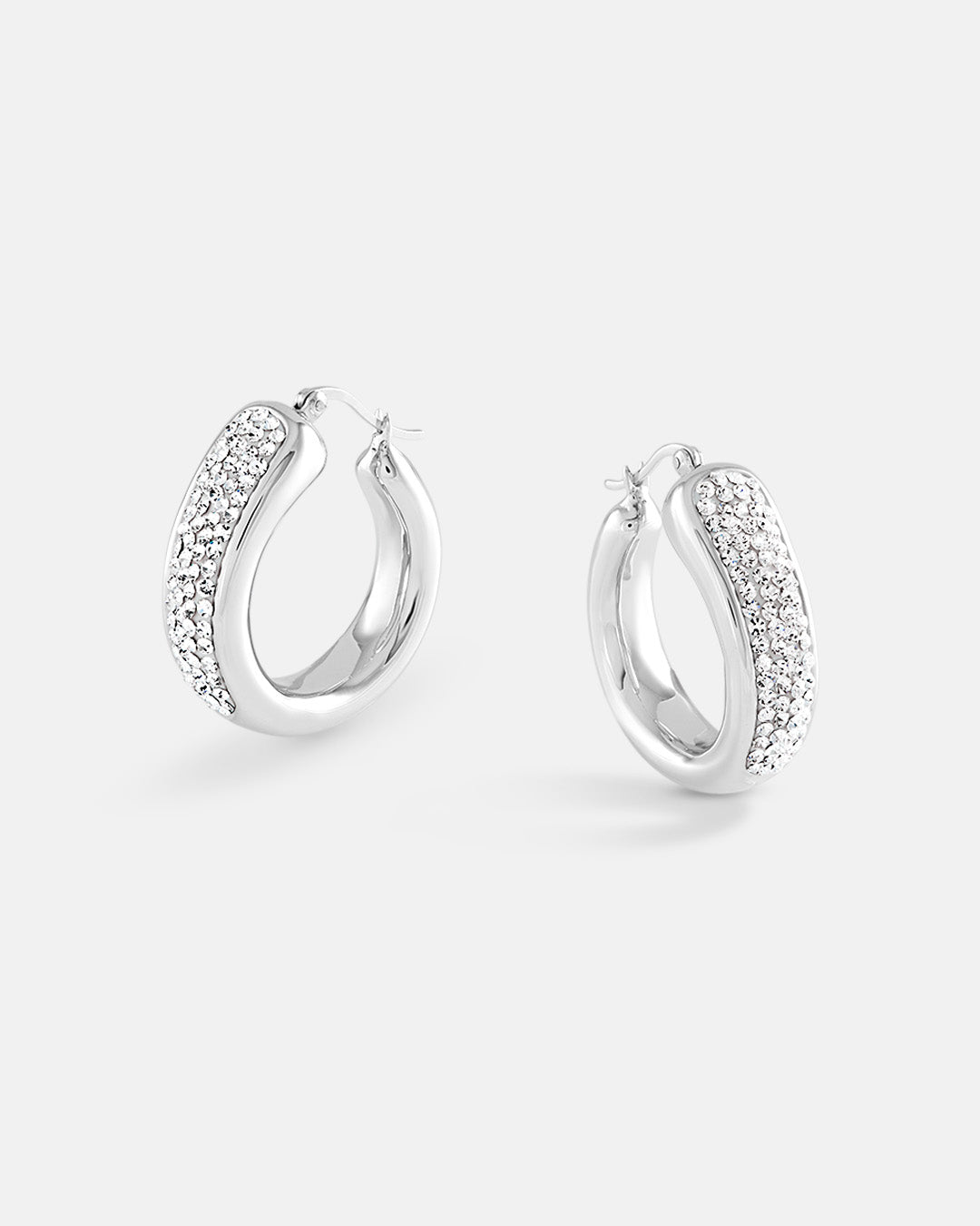 This is the product picture of a chunky statement elegant hoop earrings with micro pavé crystals plated in white gold in sterling silver material