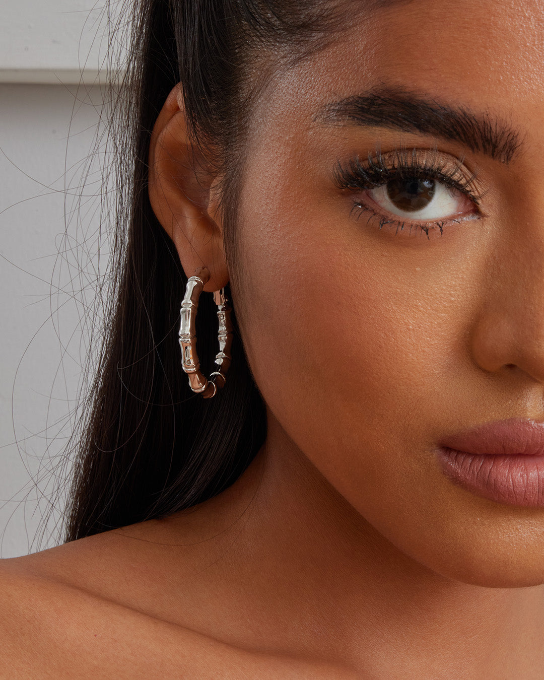 This is the product picture of bamboo style hoop earrings plated in white gold in sterling silver material