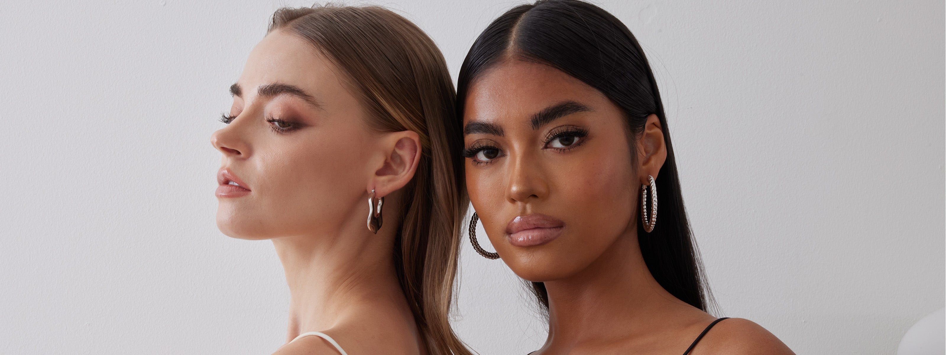 Two Models Wearing Hoop Earrings 18K white gold over sterling silver