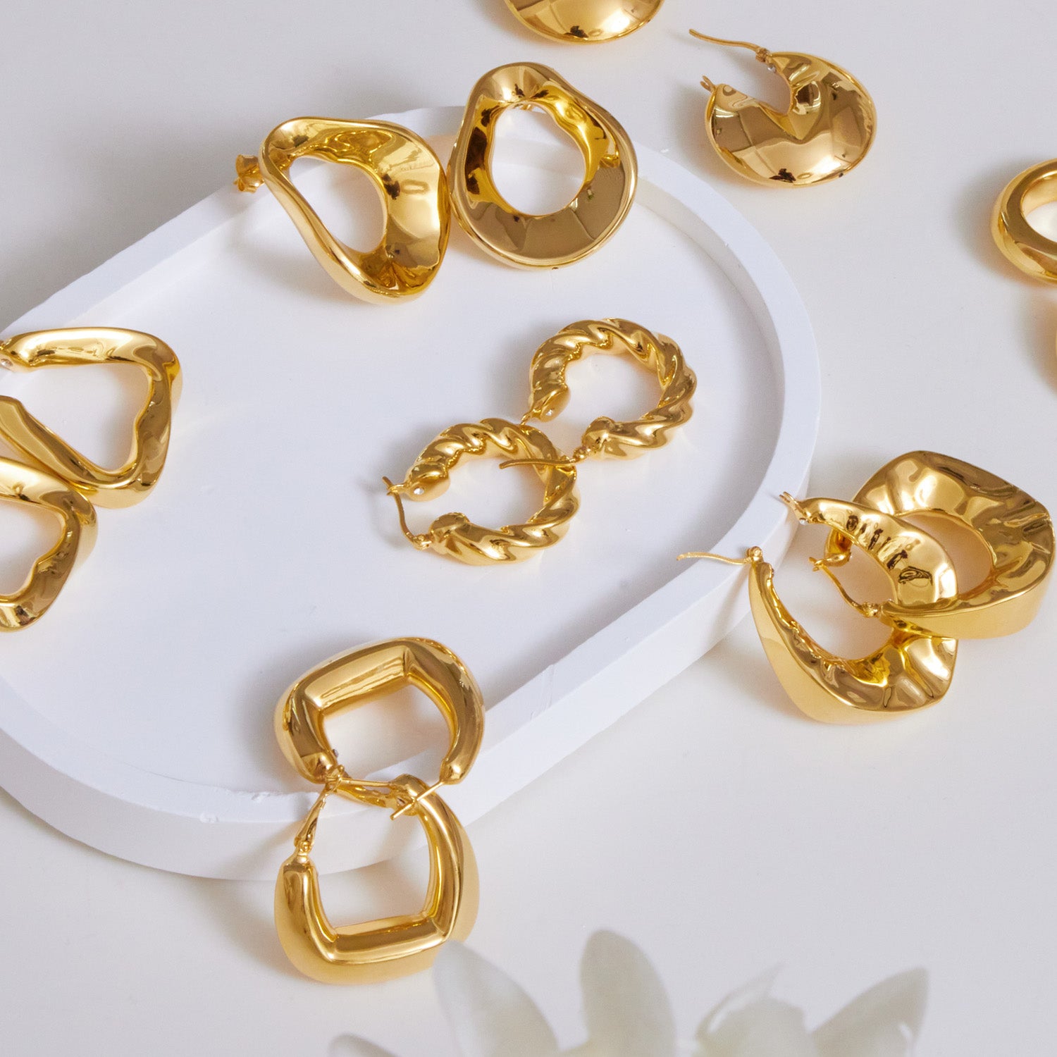 A collection of gold plated chunky hoop earrings used for collection picture