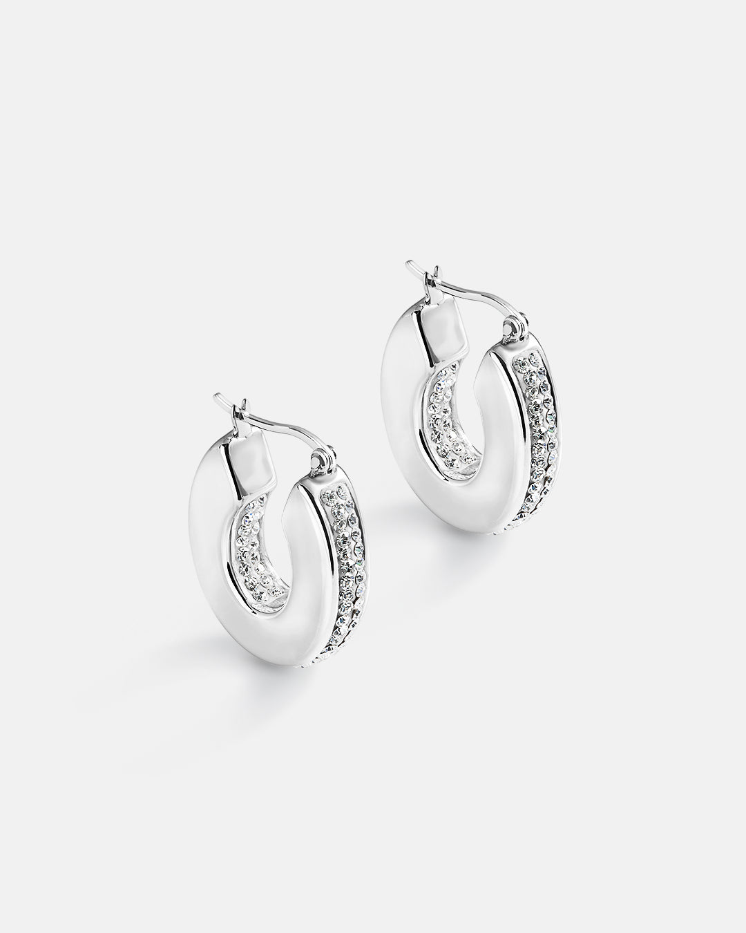 This is the product picture of chunky hoop earrings with micro pavé crystals plated in white gold in sterling silver material