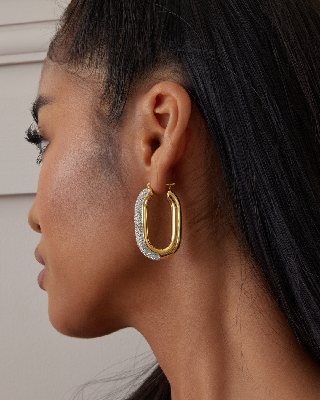 This is the product picture of elegant hoop earrings with micro pavé crystals plated in gold in sterling silver material