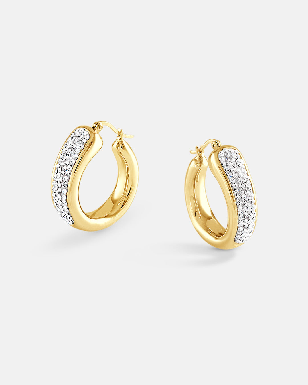 This is the product picture of a chunky statement elegant hoop earrings with micro pavé crystals plated in gold in sterling silver material