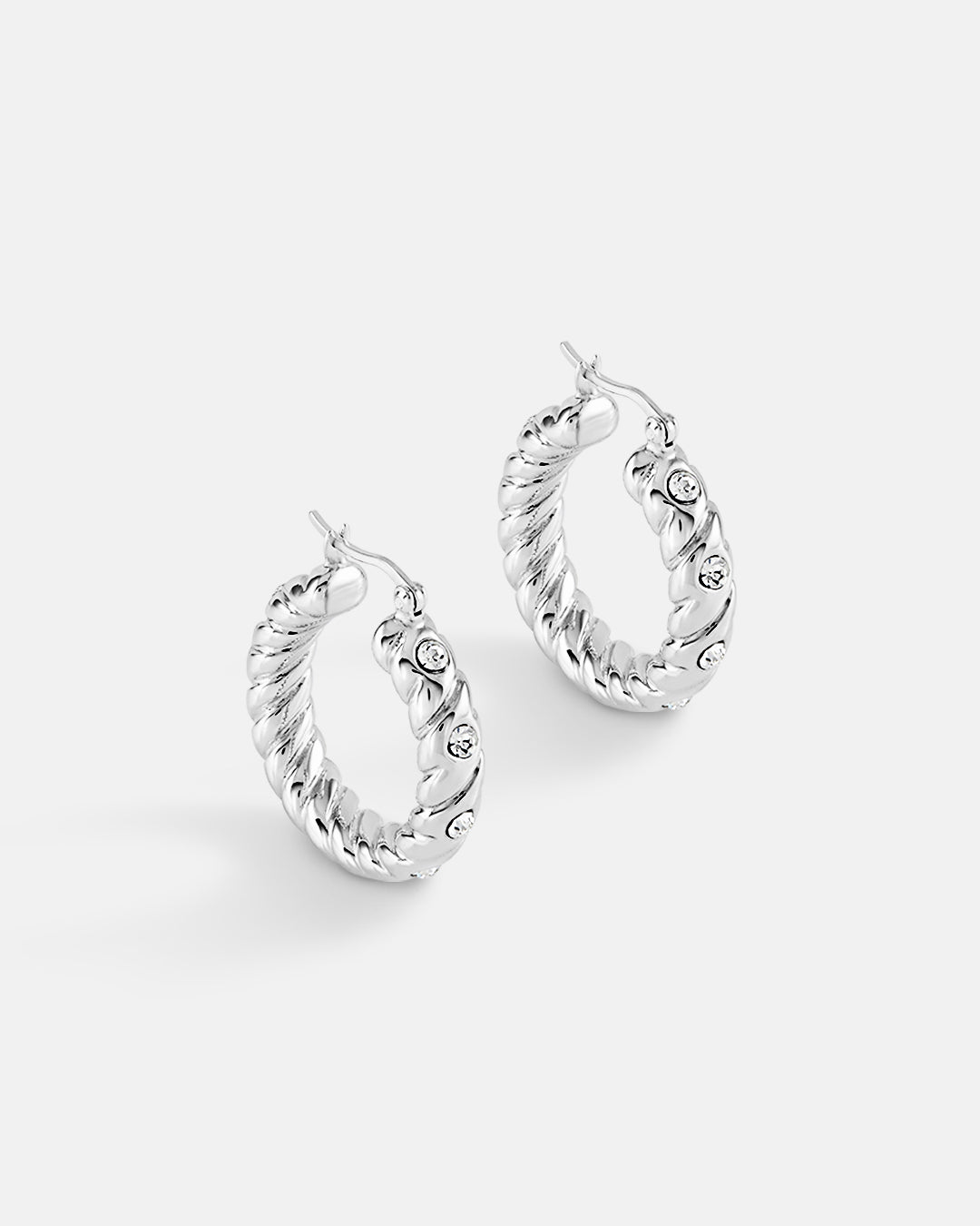 This is a product picture of a classical twisted rope pattern design with accented crystal set around the hoops earrings plated in white gold in sterling silver material