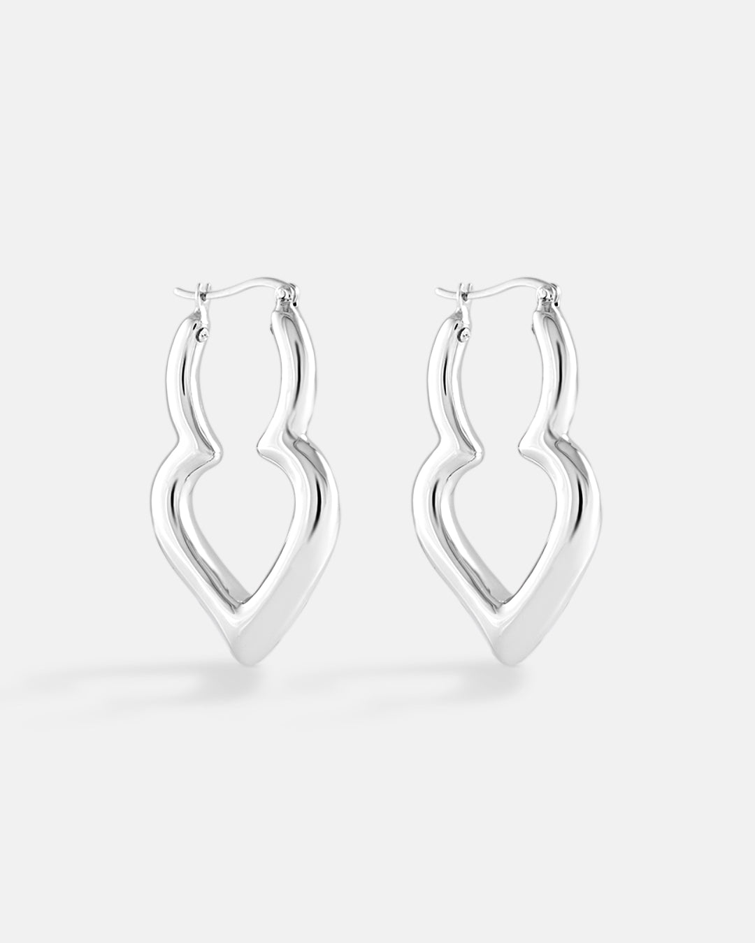 This is the product picture of elongated freeform shaped hoop earrings plated in white gold in sterling silver material