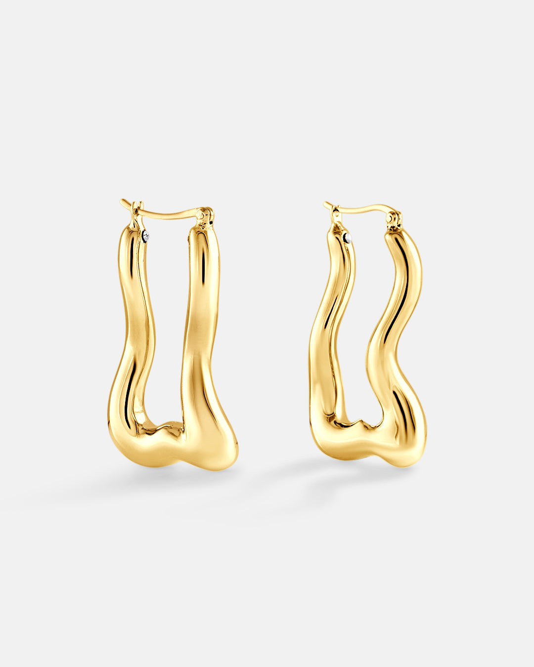 This is product picture of a wavy organic style elongated hoop earring plated in gold in sterling silver material