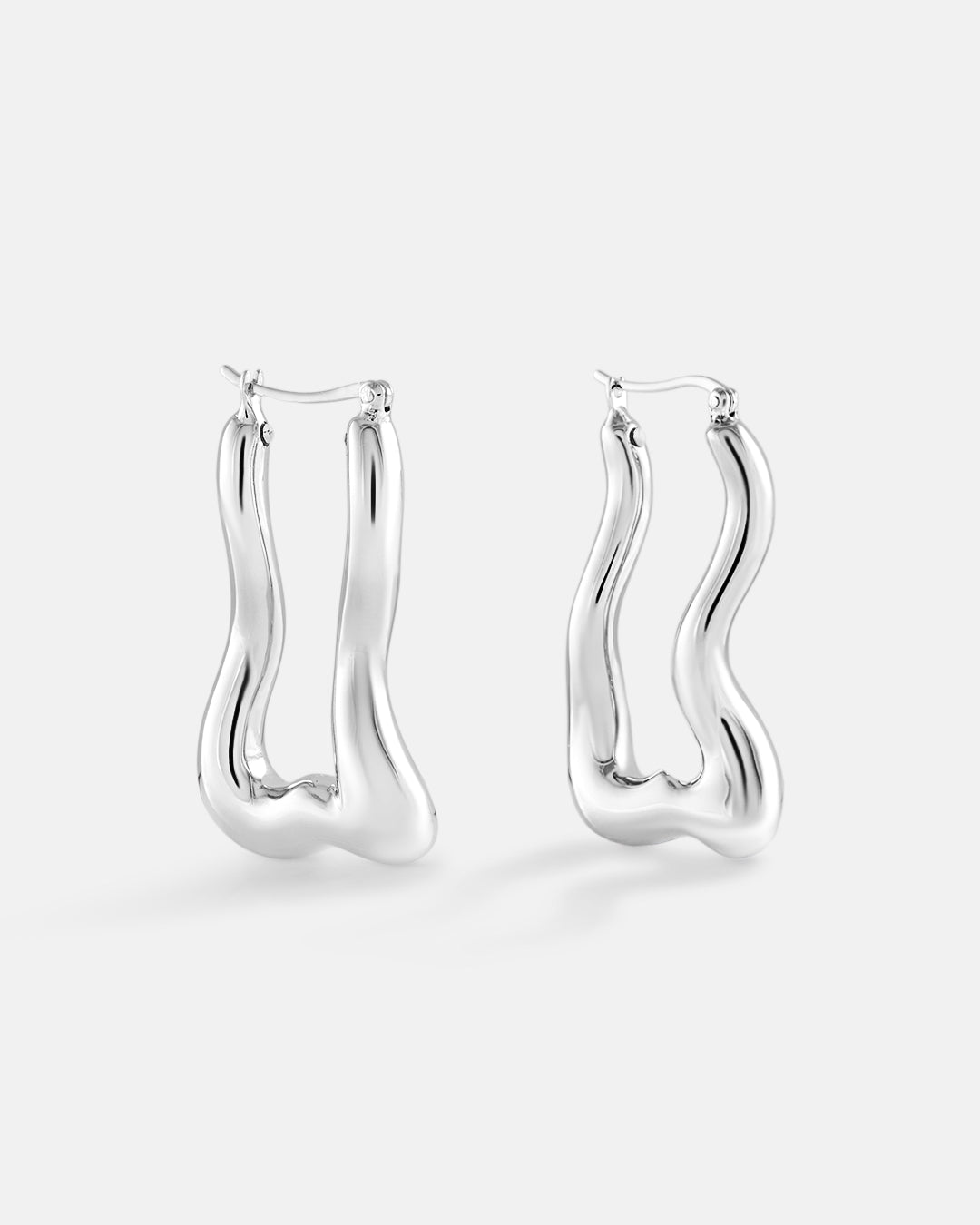 This is product picture of a wavy organic style elongated hoop earring plated in white gold in sterling silver material