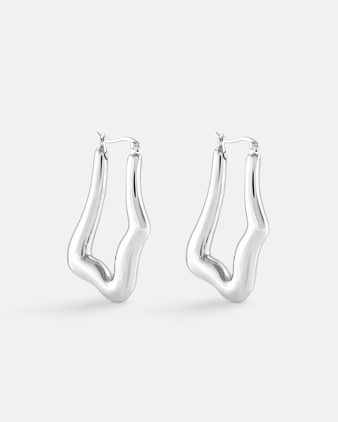 This is the product picture of organic shape elongated style hoop earrings plated in white gold in sterling silver material 