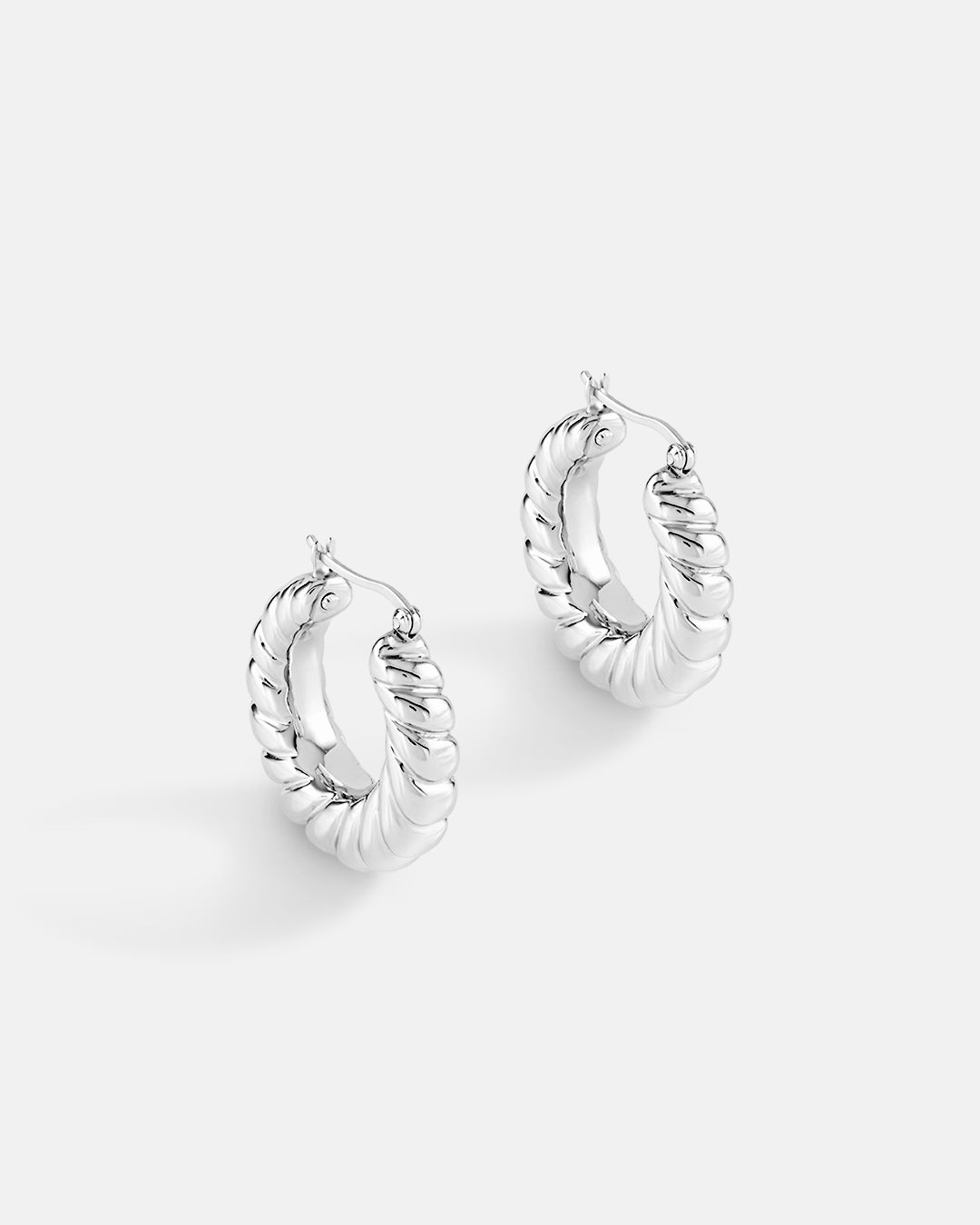 This is the product picture of classic twisted hoop earrings plated in white gold in sterling silver material