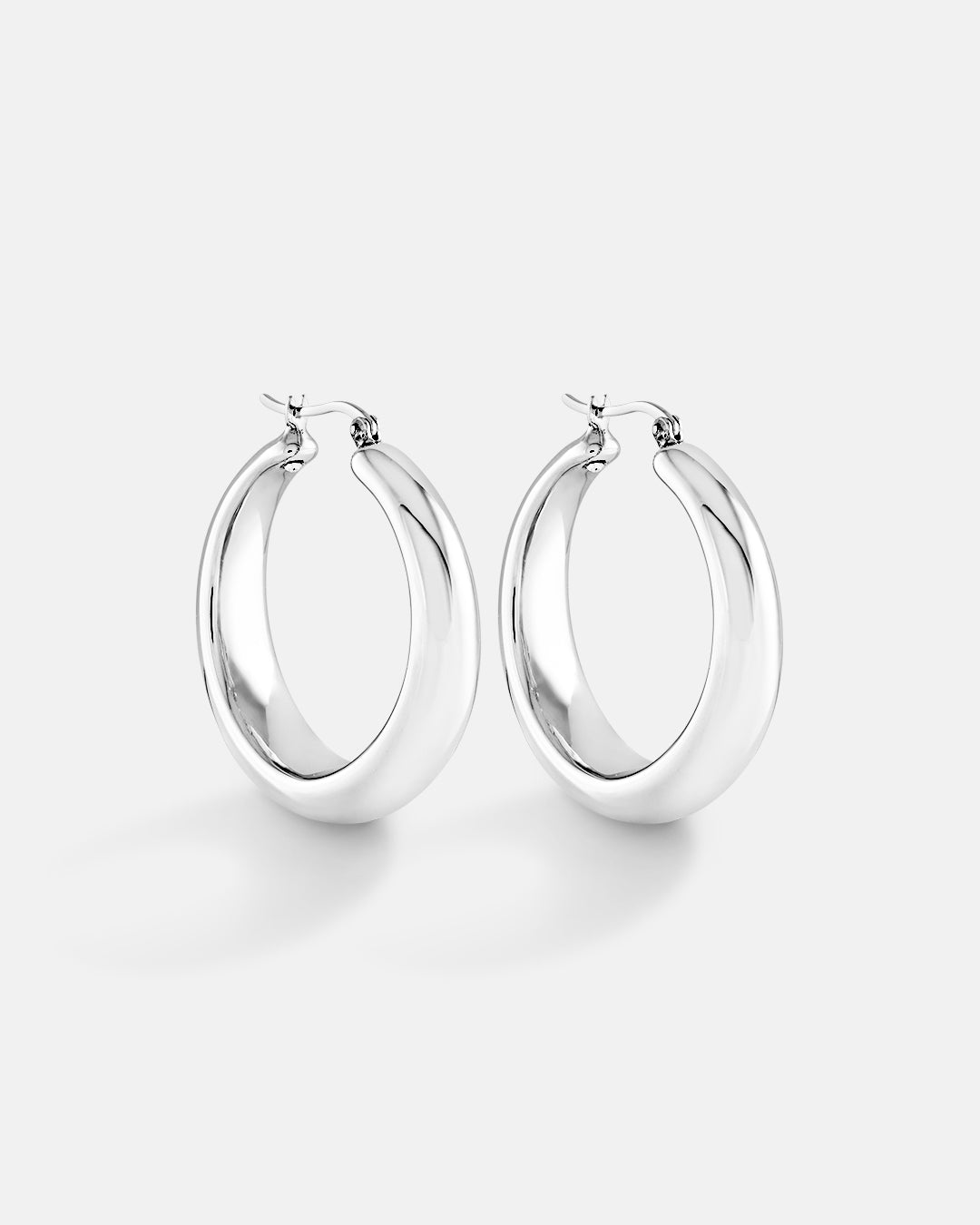 This is the product picture of round chunky hoop earrings plated in white gold in sterling silver material