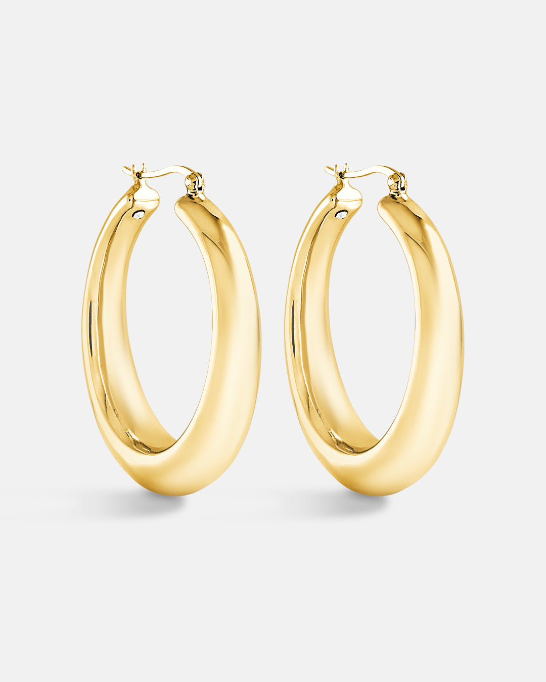 This is a product picture of chunky elongated oval shape hoop earring plated in gold in sterling silver material