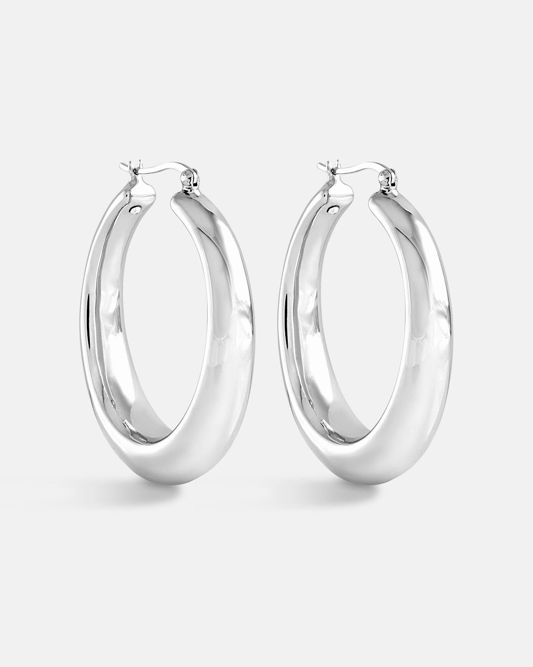 This is a product picture of chunky elongated oval shape hoop earring plated in white gold in sterling silver material