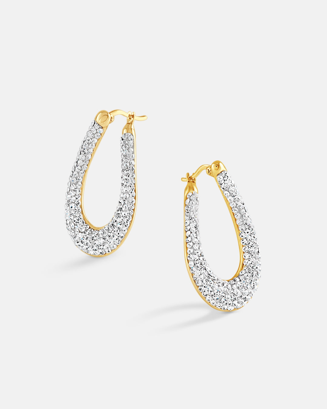 This is the product picture of elegant hoop earrings with micro pavé crystals plated in gold in sterling silver material