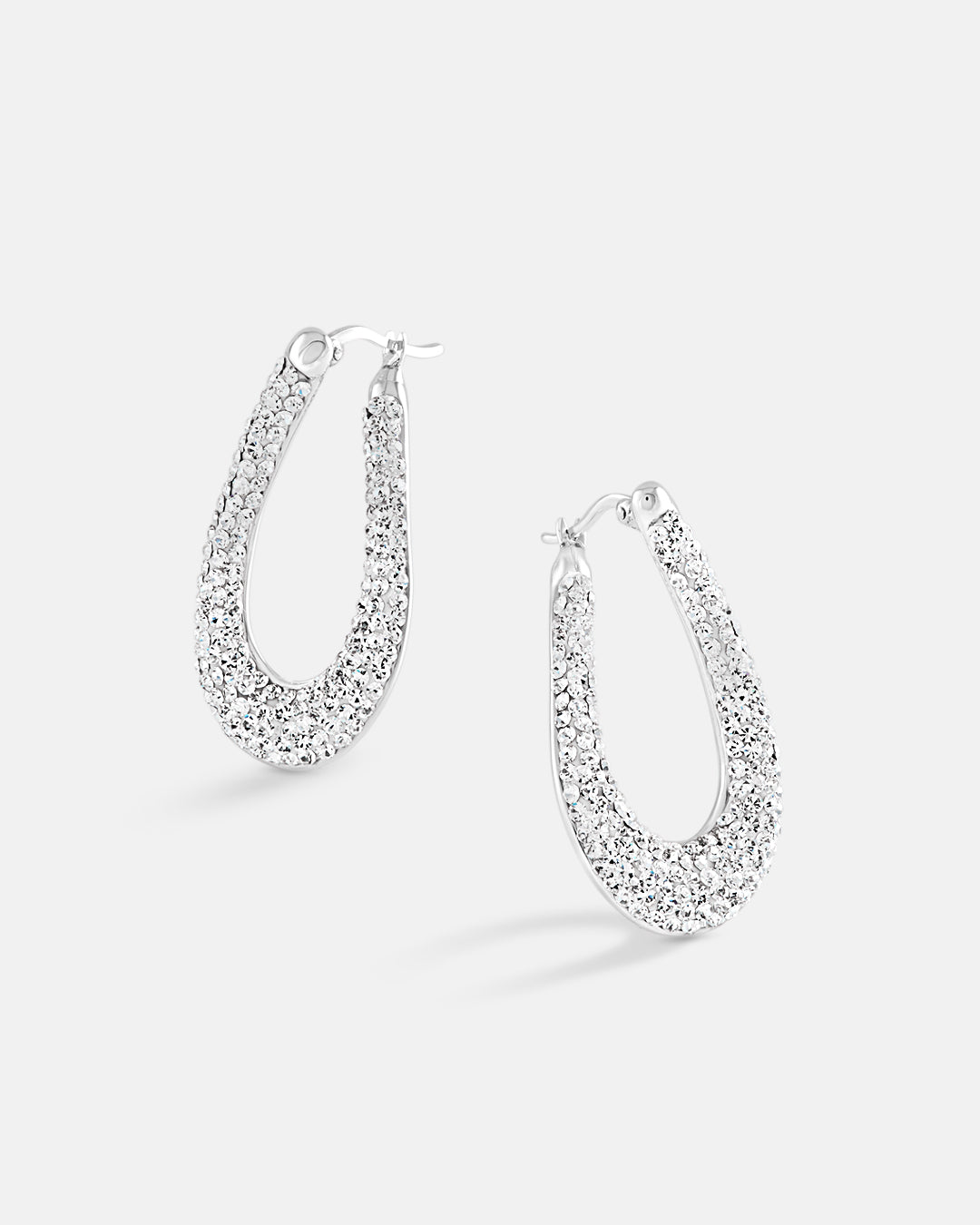 This is the product picture of elegant hoop earrings with micro pavé crystals plated in white gold in sterling silver material