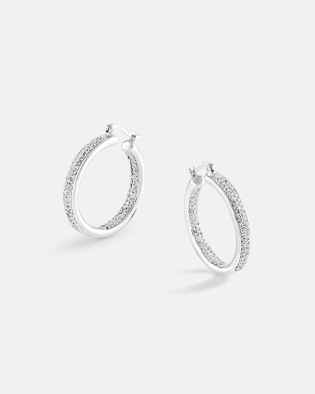 This is the product picture of elegant hoop earrings with micro pavé crystals plated in white gold in sterling silver material