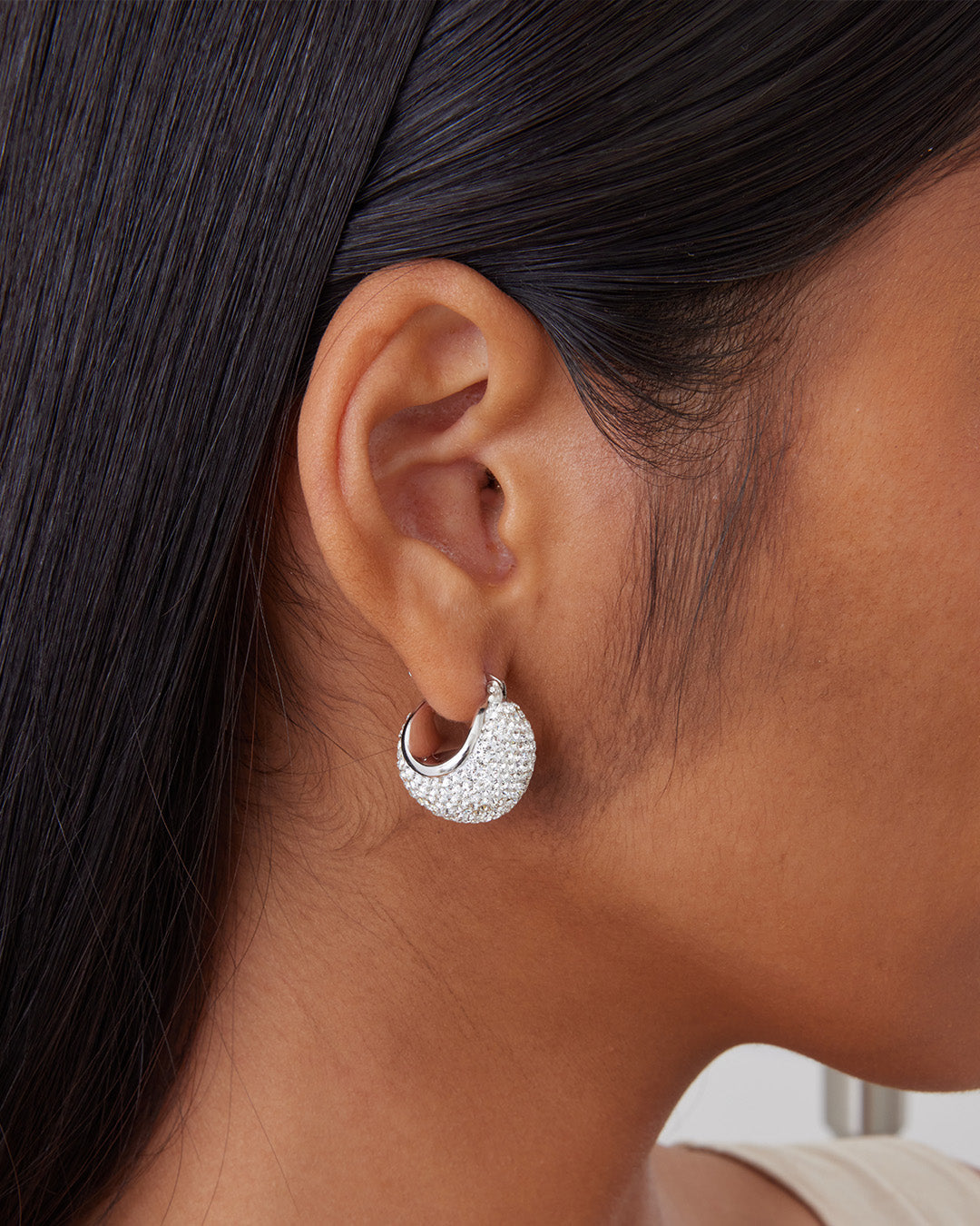 This is the product picture of the disco ball hoop earrings made from crystals plated in white gold in sterling silver material