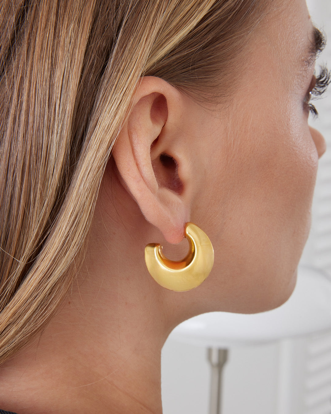 This is the product picture of chunky hoop earrings plated in gold in sterling silver material