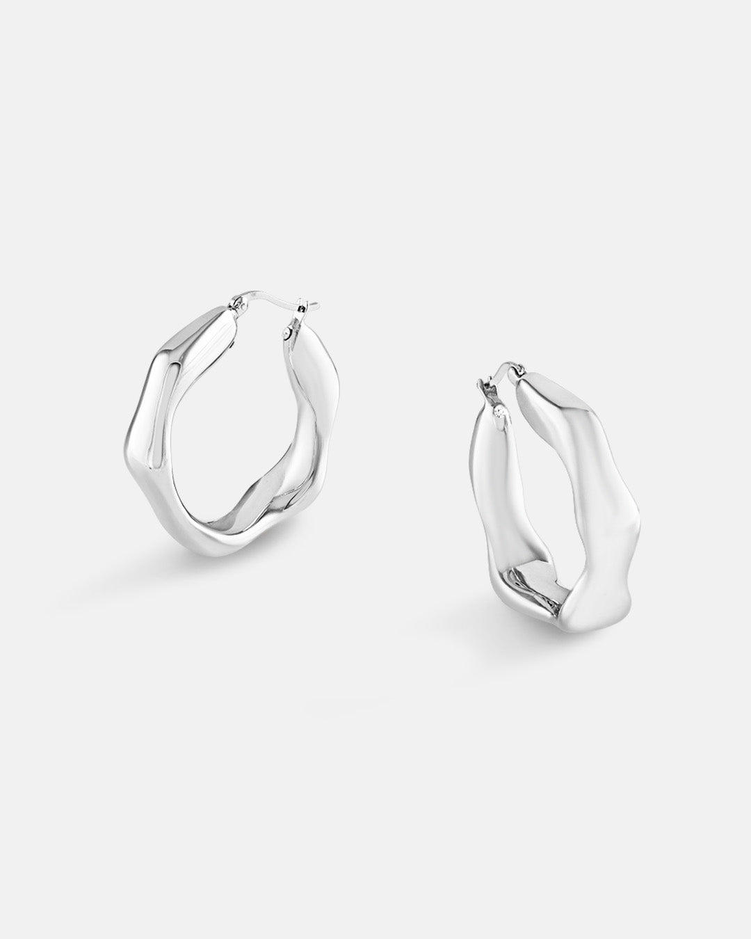 This is the product picture of heptagon shape hoop earrings plated in white gold in sterling silver material