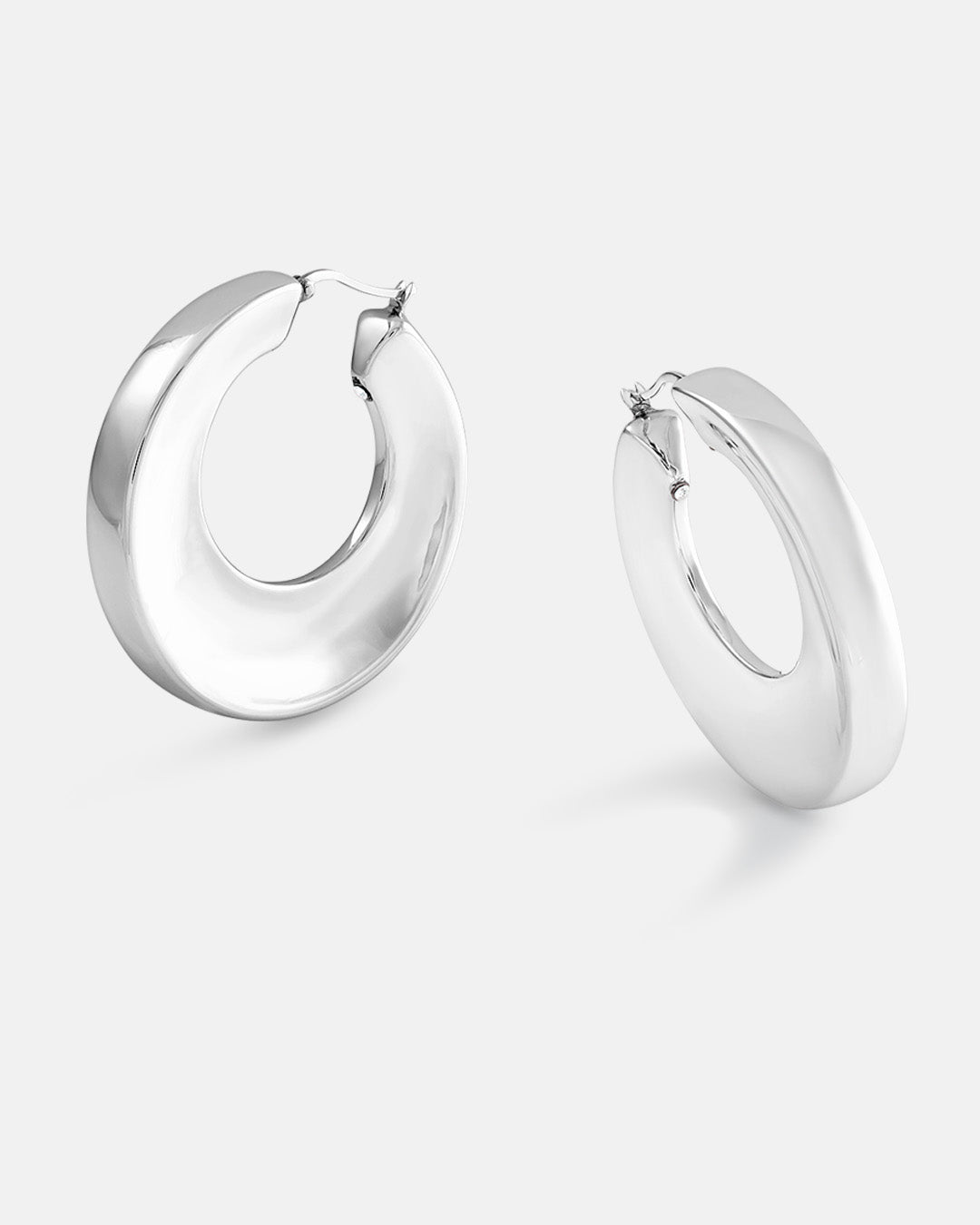 This is product picture of a large round shape organic hoop earrings with a slightly chunky look plated in white gold in sterling silver material