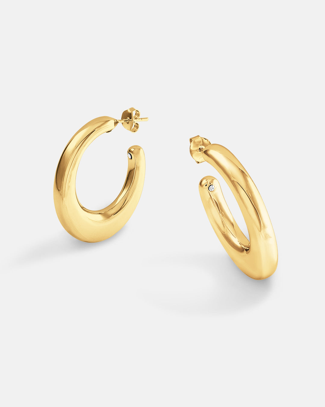 This is the product picture of organic shape elongated style hoop earrings plated in gold in sterling silver material