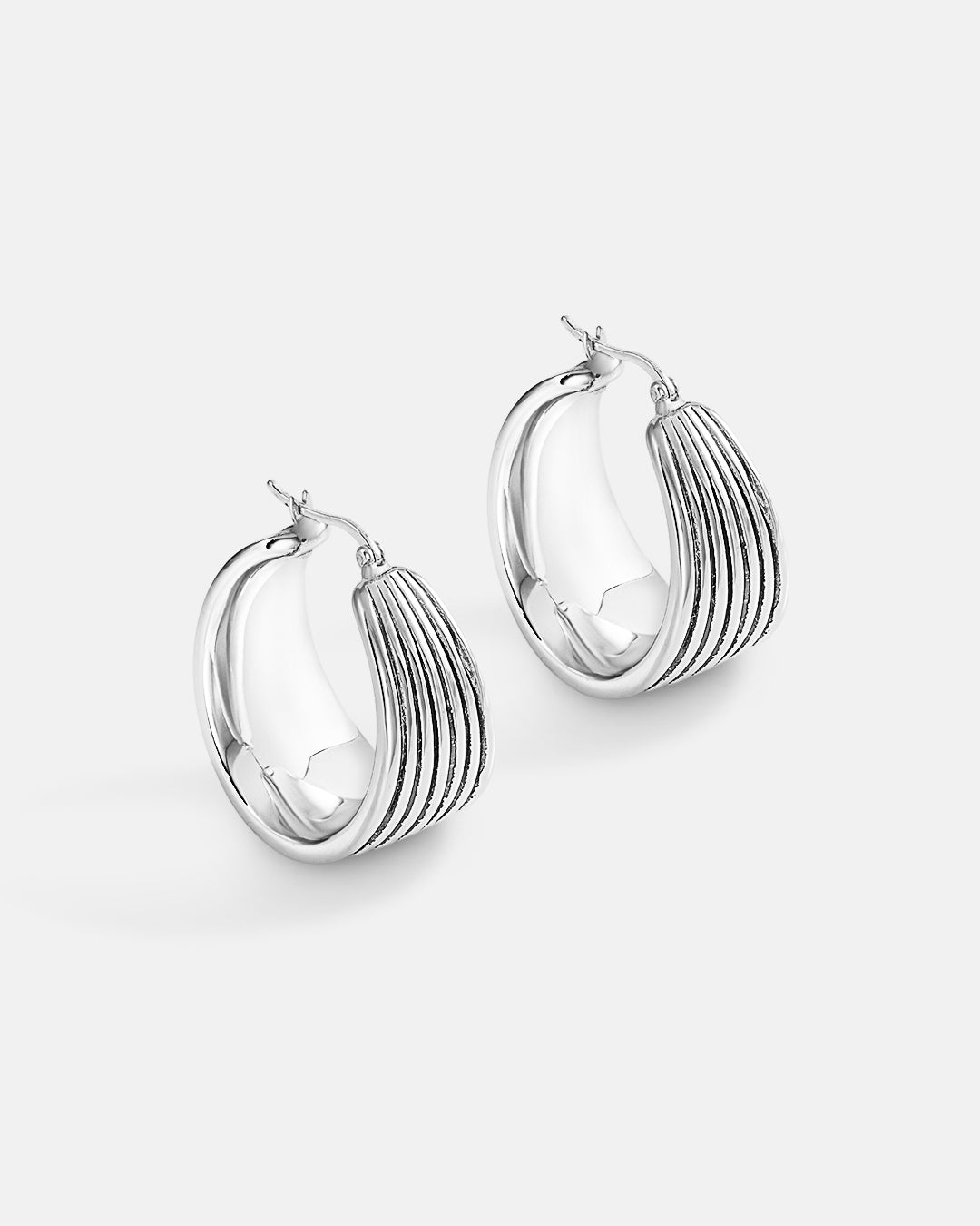 This is the product picture of chunky oxidized line pattern hoop earrings plated in white gold in sterling silver material
