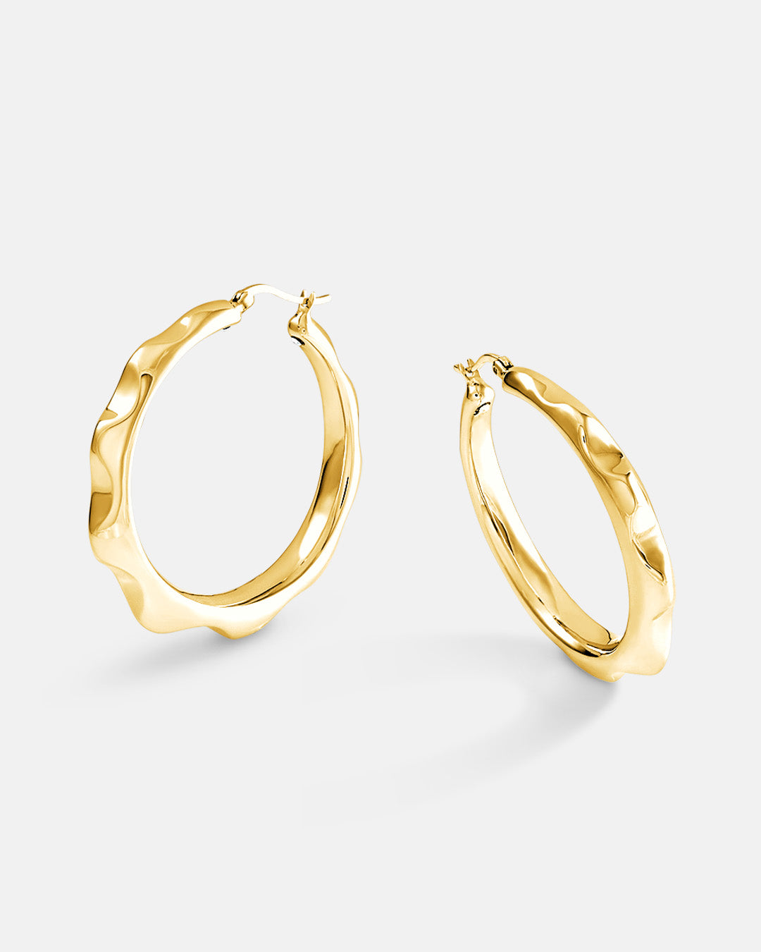 This is the product picture of freeform spiked rounded hoop earrings plated in gold in sterling silver material