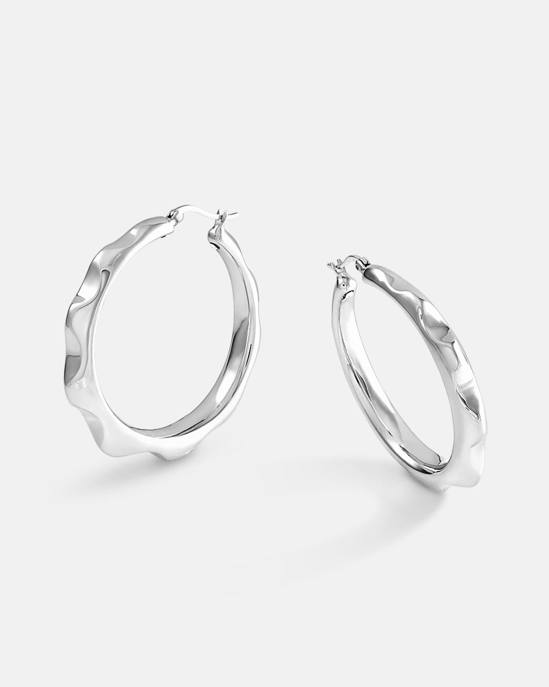 This is the product picture of freeform spiked rounded hoop earrings plated in white gold in sterling silver material