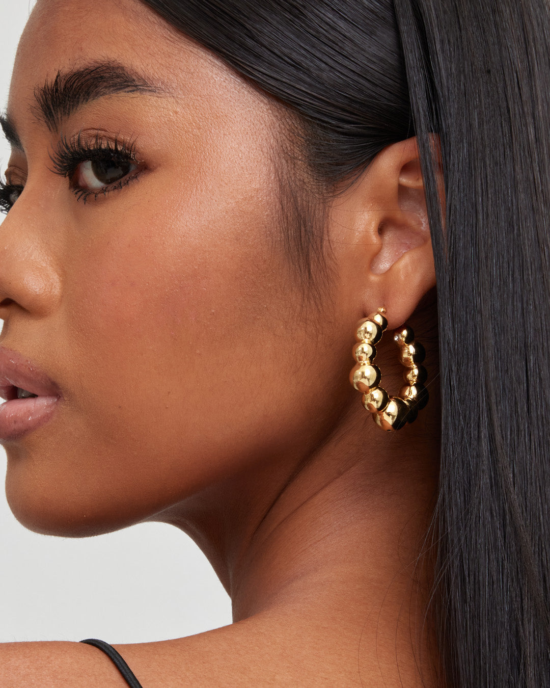This is the product picture of a chunky style hoop that has a uneven organic bubbles shape earrings plated in gold in sterling silver material