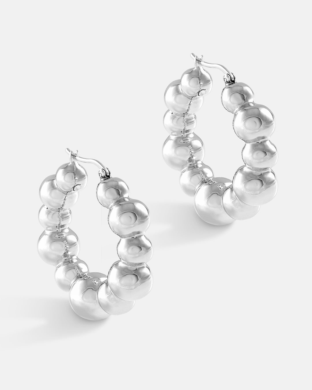 This is the product picture of a chunky style hoop that has a uneven organic bubbles shape earrings plated in white gold in sterling silver material