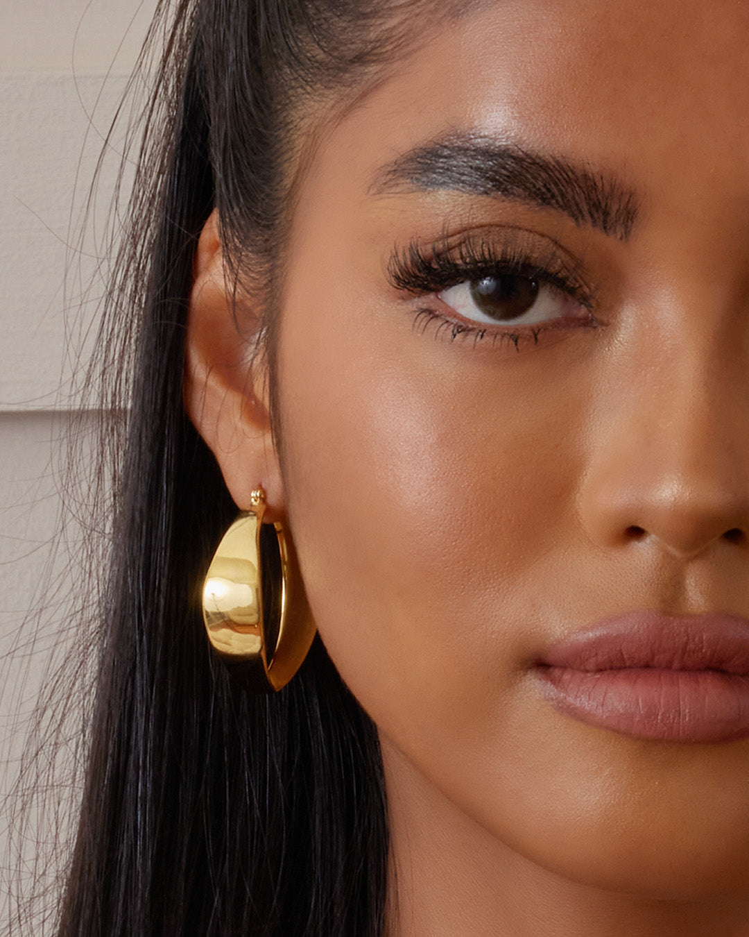 This is the product picture of chunky hoop earrings plated in gold in sterling silver material