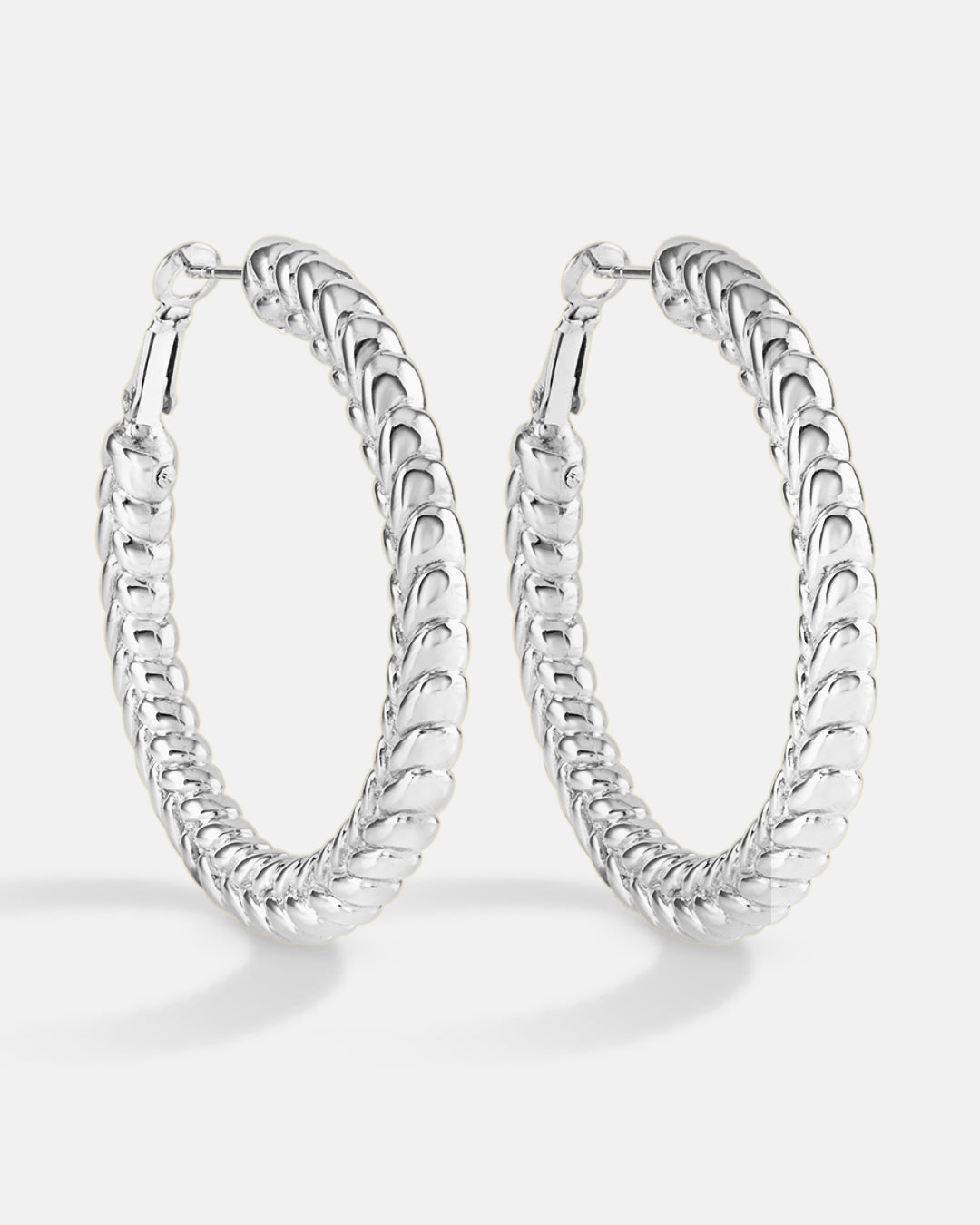 This is the product picture of flat tree leaves design hoop earrings plated in white gold in sterling silver material