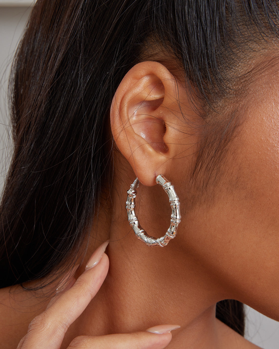 This is the product picture of bamboo style hoop earrings plated in white gold in sterling silver material