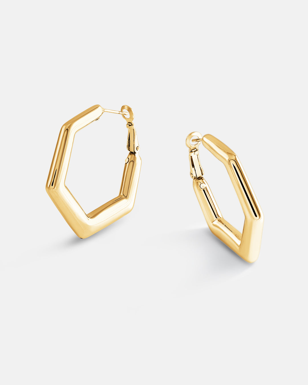 This is the product picture of a minimal hexagon design hoop earrings plated in gold in sterling silver material