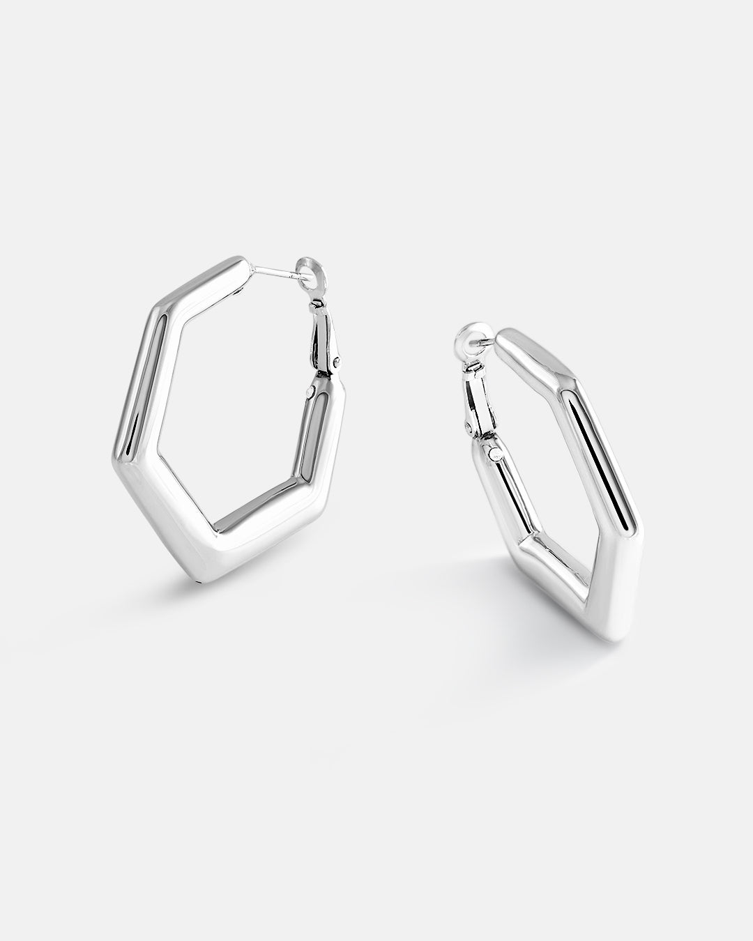 This is the product picture of a minimal hexagon design hoop earrings plated in white gold in sterling silver material