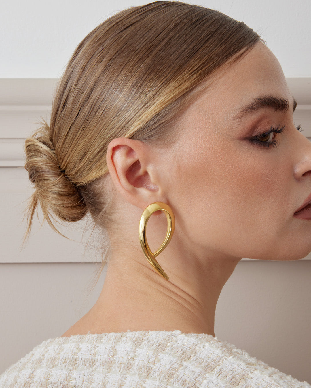 This is the product picture of oversized modern design hoop earrings plated in gold in sterling silver material