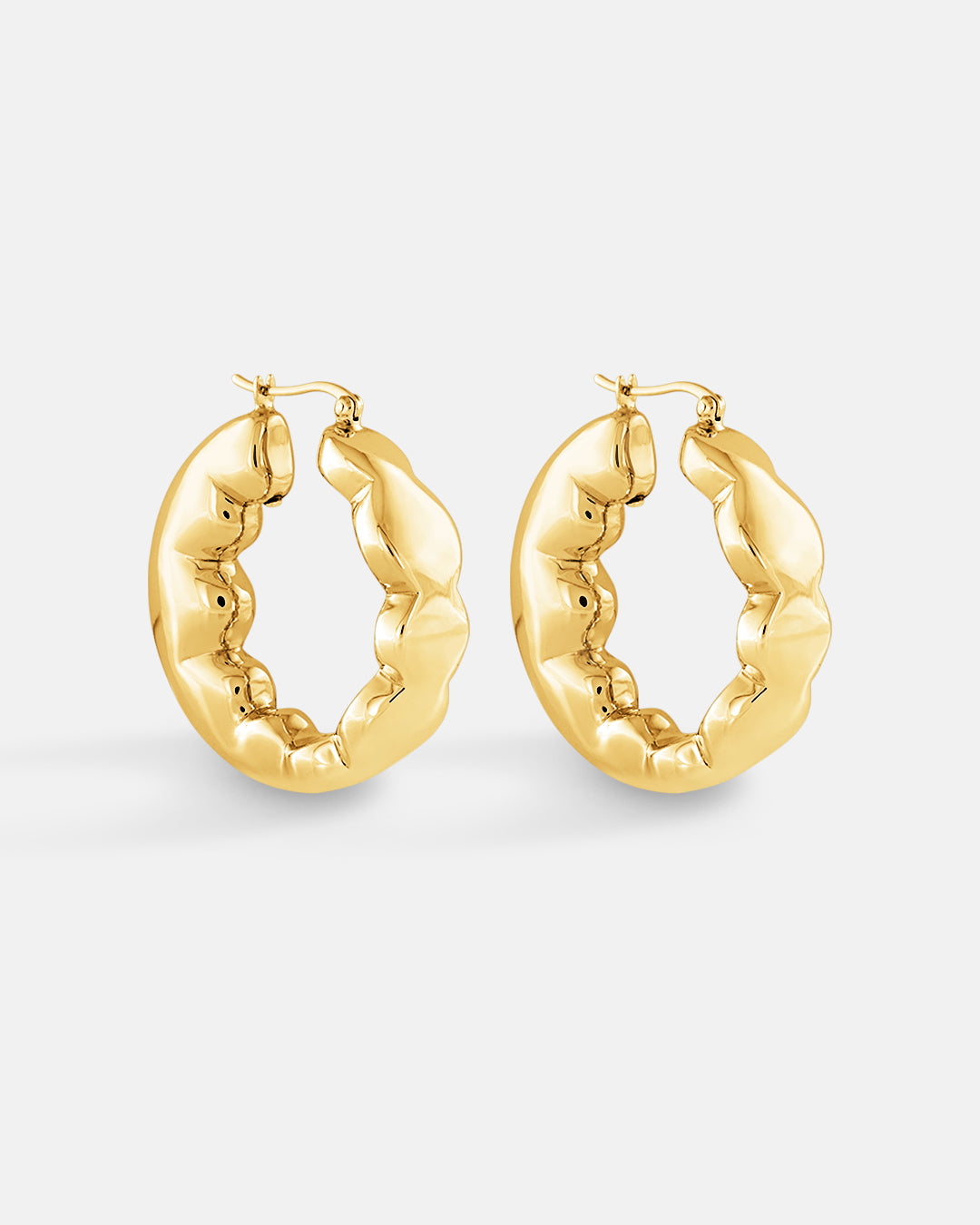 This is the product picture of freeform organic round shape hoop earrings plated in gold in sterling silver material