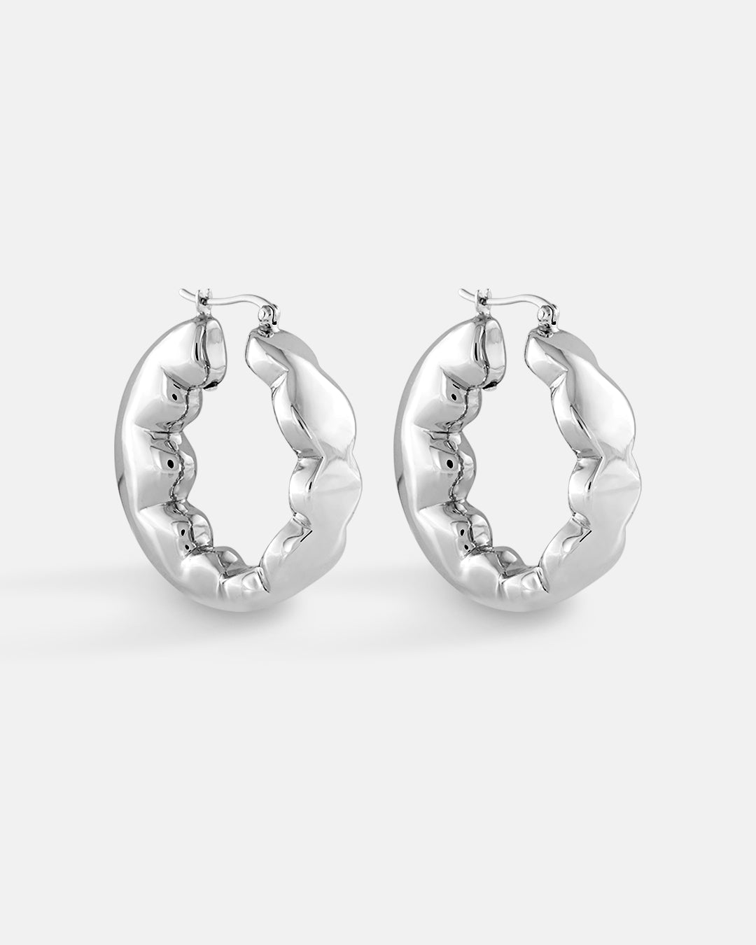 This is the product picture of freeform organic round shape hoop earrings plated in white gold in sterling silver material