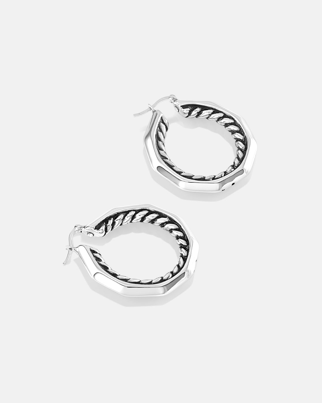 This is the product picture of a decagon shaped hoop earrings with a twisted rope design pattern plated in white gold in sterling silver material