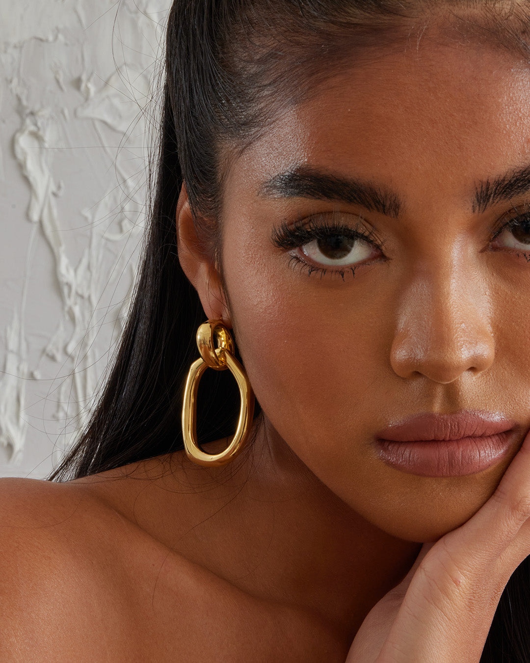 This is the product picture of a oversized drop-down dangle with a freeform shape earrings plated in gold in sterling silver material