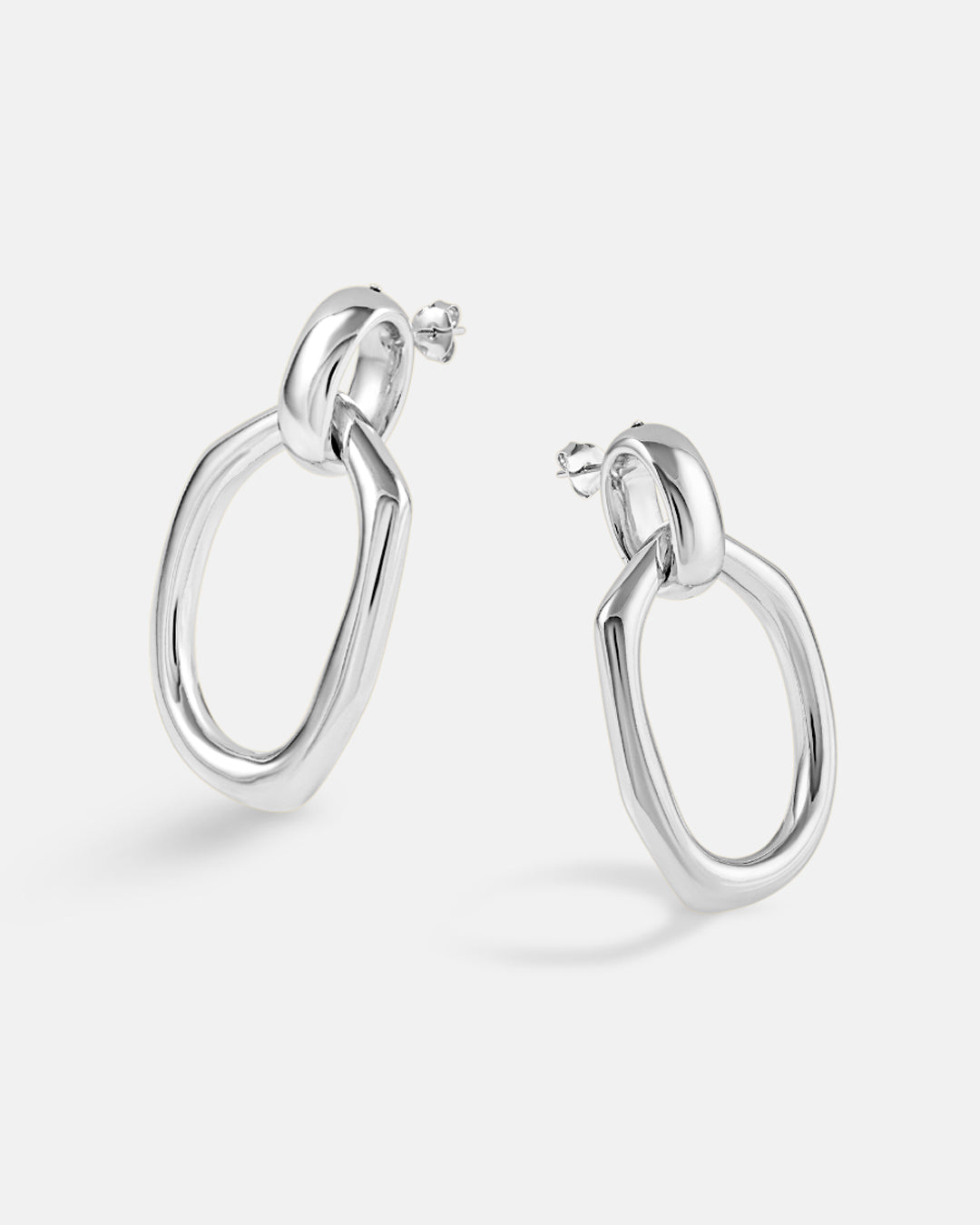 This is the product picture of a oversized drop-down dangle with a freeform shape earrings plated in white gold in sterling silver material