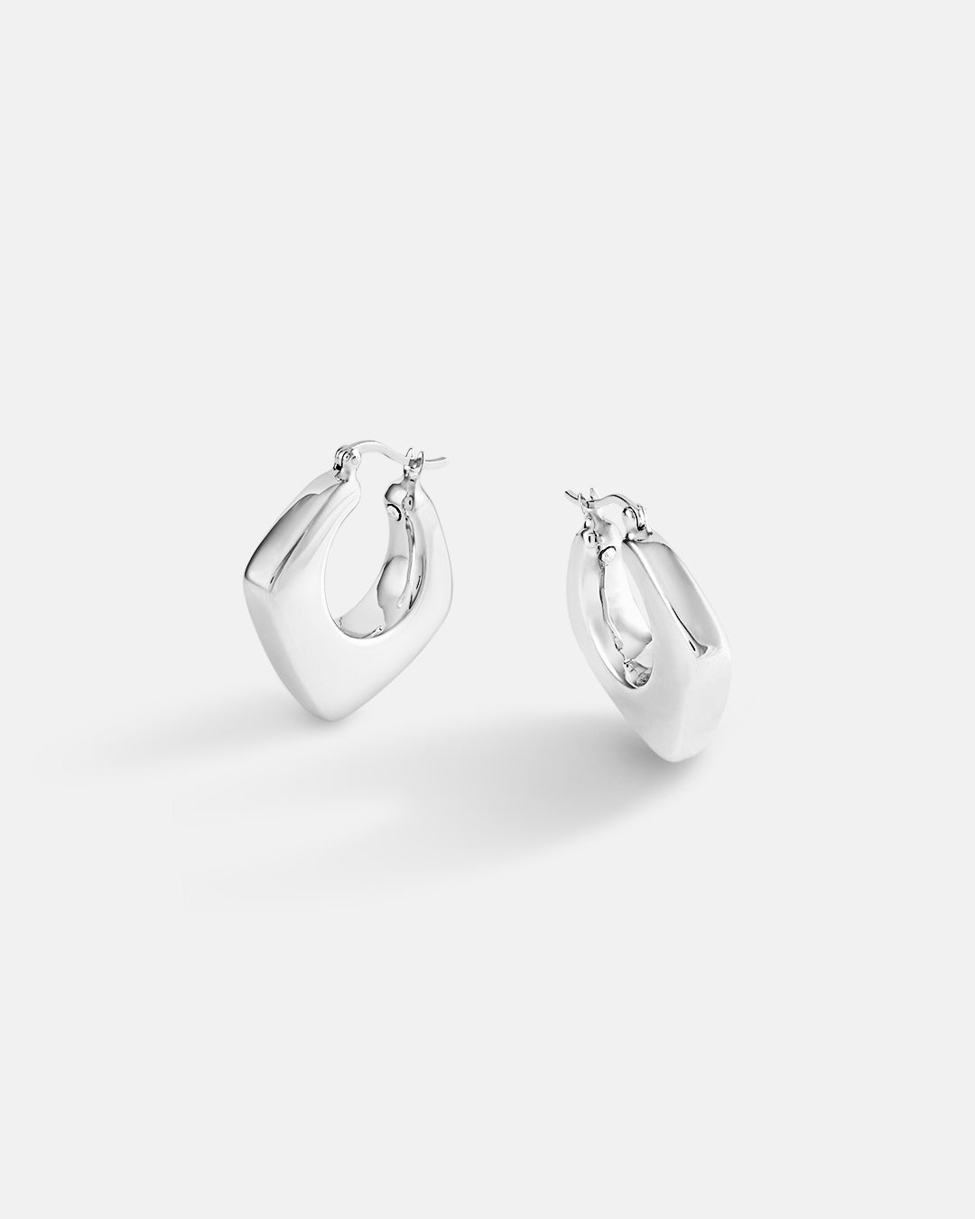 This is the product picture of luxury huggie hoop earrings plated in white gold in sterling silver material