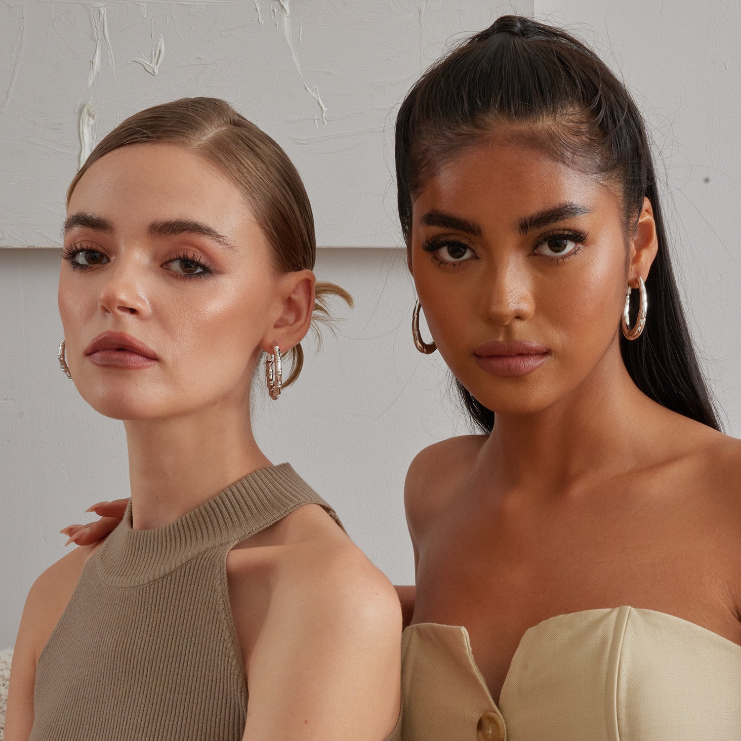 2 Models wearing sterling silver hoop earrings